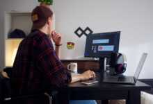 man sitting near table using computer