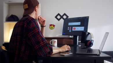 man sitting near table using computer