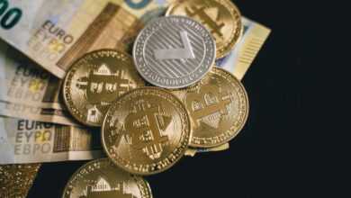 Close-up of bitcoins and euro banknotes, representing modern finance and digital currency exchange.