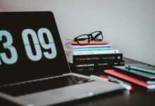 silver MacBook Pro near books