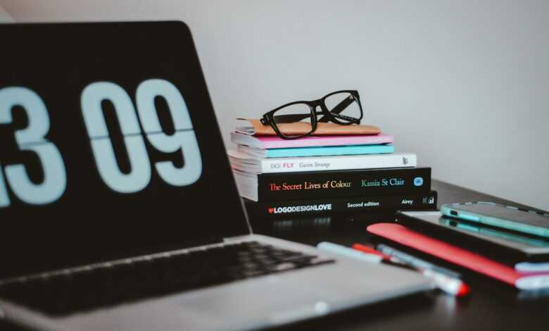 silver MacBook Pro near books