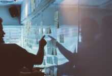 person pointing white paper on wall