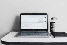 a laptop computer sitting on top of a white desk