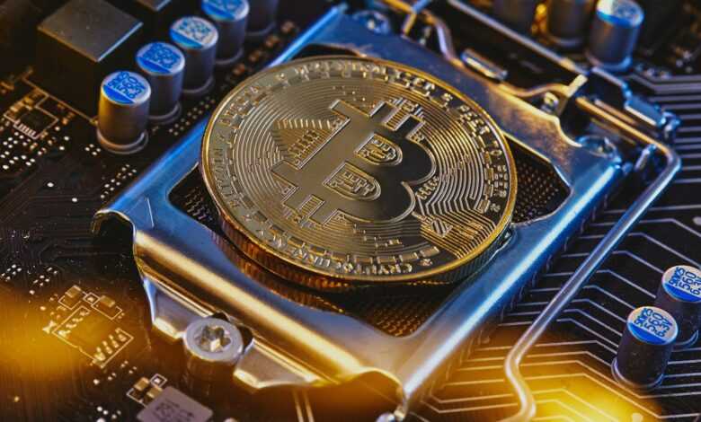 a bitcoin sitting on top of a computer motherboard
