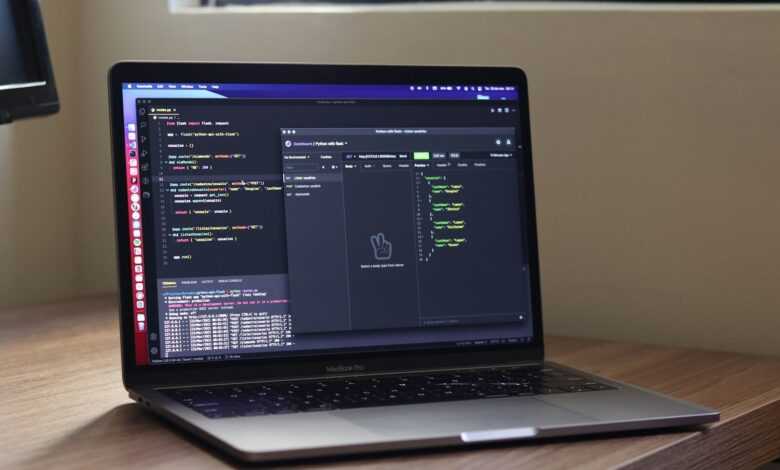 a laptop computer sitting on top of a wooden desk
