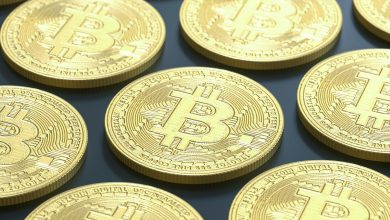 a pile of gold bitcoins sitting on top of a table