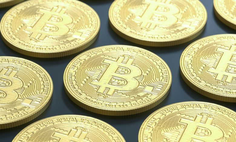 a pile of gold bitcoins sitting on top of a table