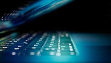 closeup photo of turned-on blue and white laptop computer
