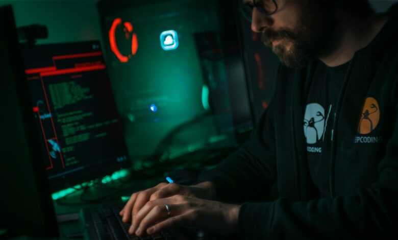 man in black jacket using computer