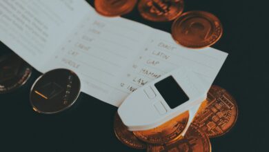 a cell phone sitting on top of a pile of coins