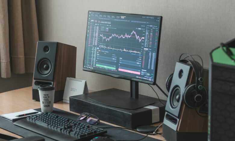 black flat screen computer monitor turned on beside black computer keyboard