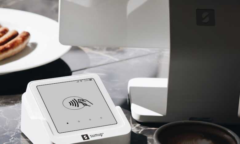 A table topped with a laptop computer next to a cup of coffee
