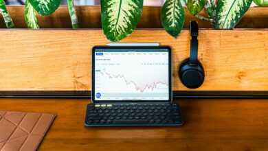 a laptop computer sitting on top of a wooden desk