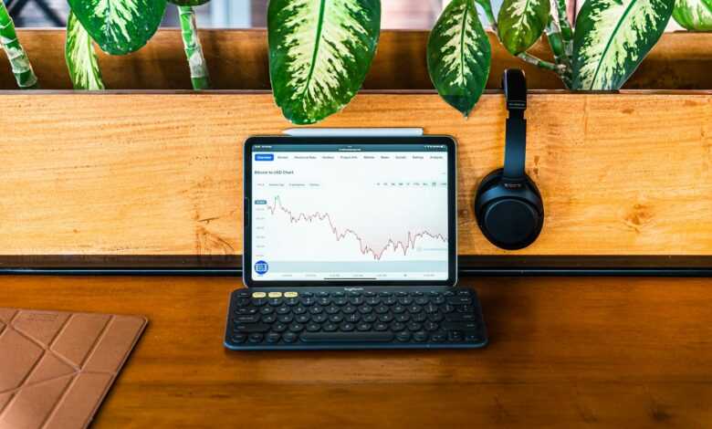 a laptop computer sitting on top of a wooden desk