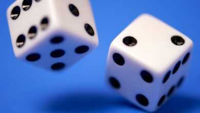 2 white dices on blue surface