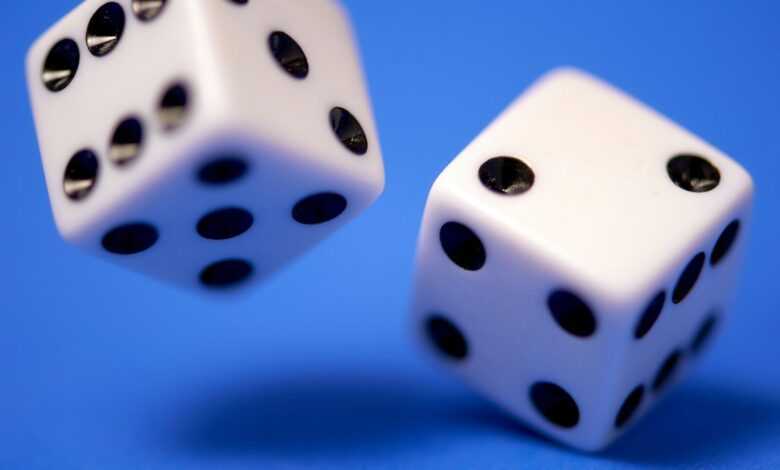 2 white dices on blue surface