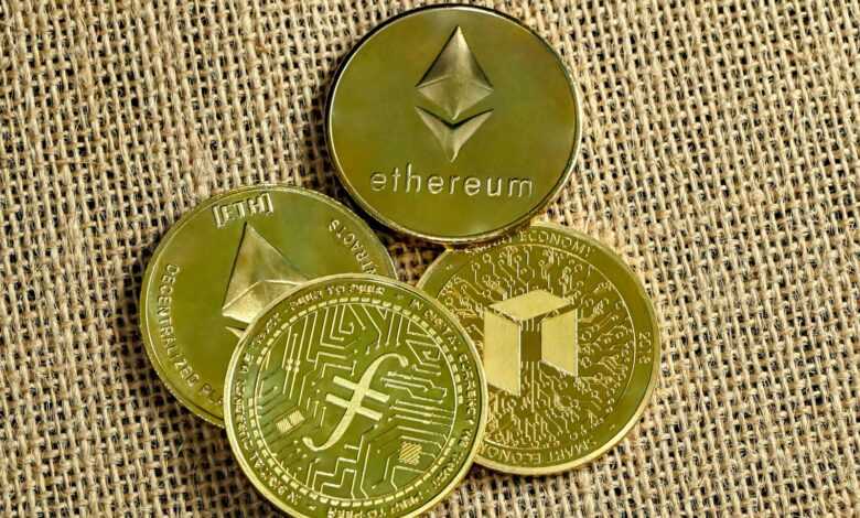 three gold coins with a bitcoin on top of them