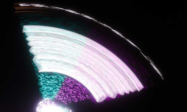 A blurry photo of a ferris wheel at night