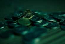 silver round coins on blue surface