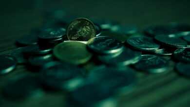 silver round coins on blue surface