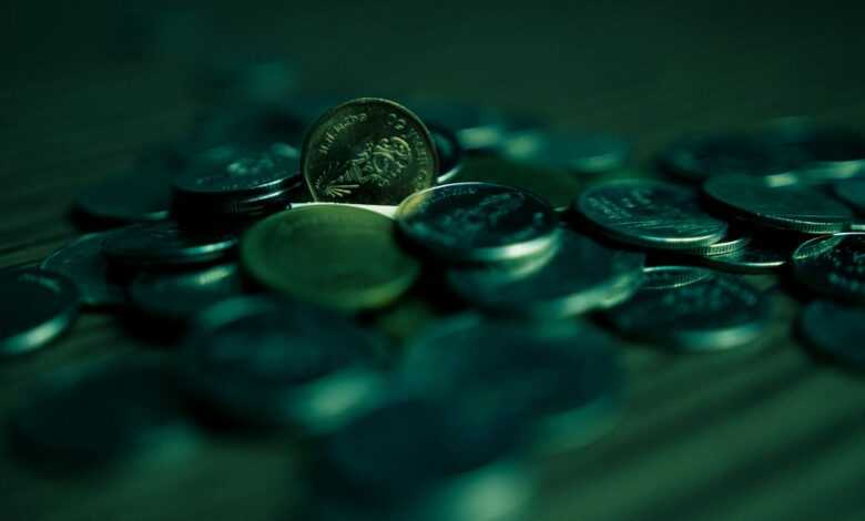silver round coins on blue surface